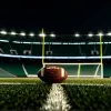 Фотореалистичное изображение футбольного поля под стадионными огнями ночью, с одним футбольным мячом на траве. Кинематографическое освещение, 8k, гиперреалистичное.